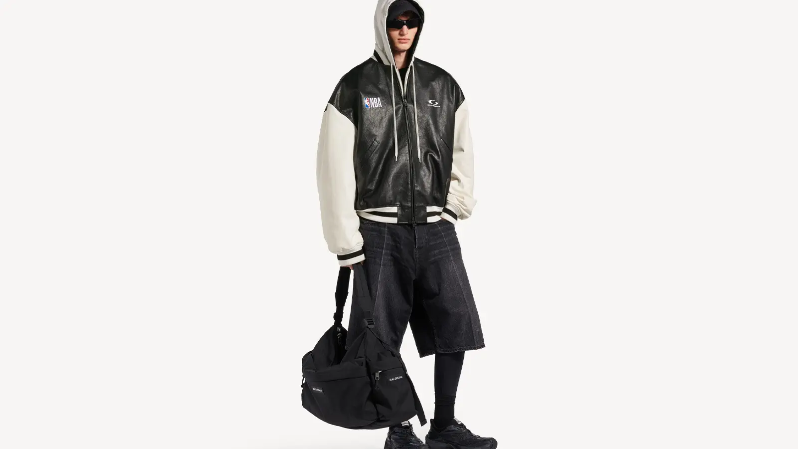 Editorial campaign image of the Balenciaga x NBA Fall 2026 collection, styled with oversized proportions and NBA tricolor branding.