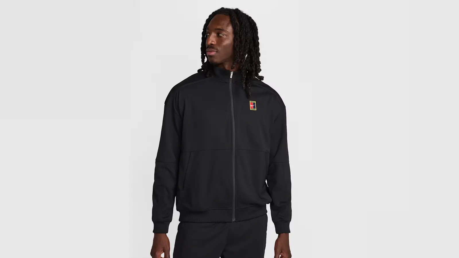 A blue track jacket featuring high-neck construction and Nike branding.