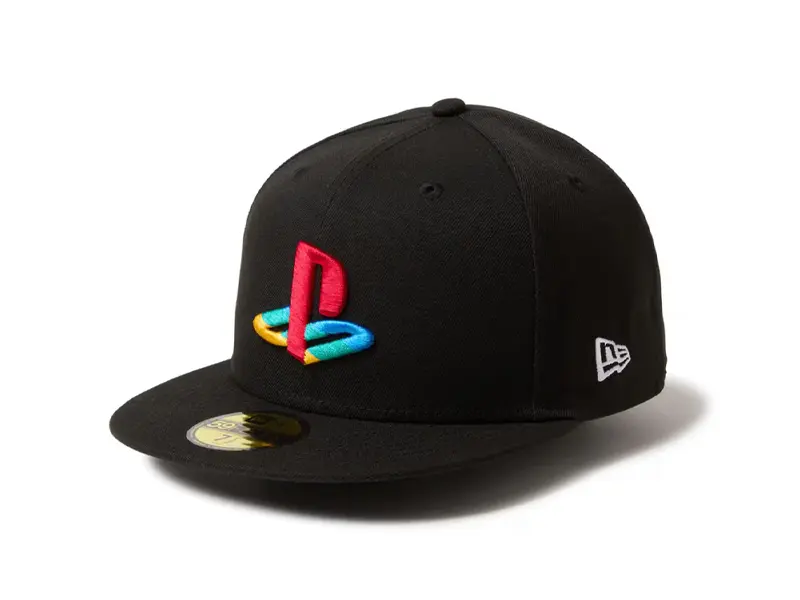 A premium PlayStation x New Era 59FIFTY fitted cap floating in a 3D digital void. The hat features raised 3D embroidery of the Triangle, Circle, Cross, and Square icons on a midnight black crown with cyan circuit-line accents in the background.