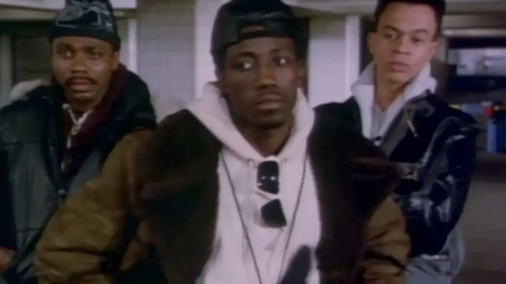 Wesley Snipes as Mini Max in Michael Jackson’s Bad video, wearing a black beanie and technical street gear in a subway station.
