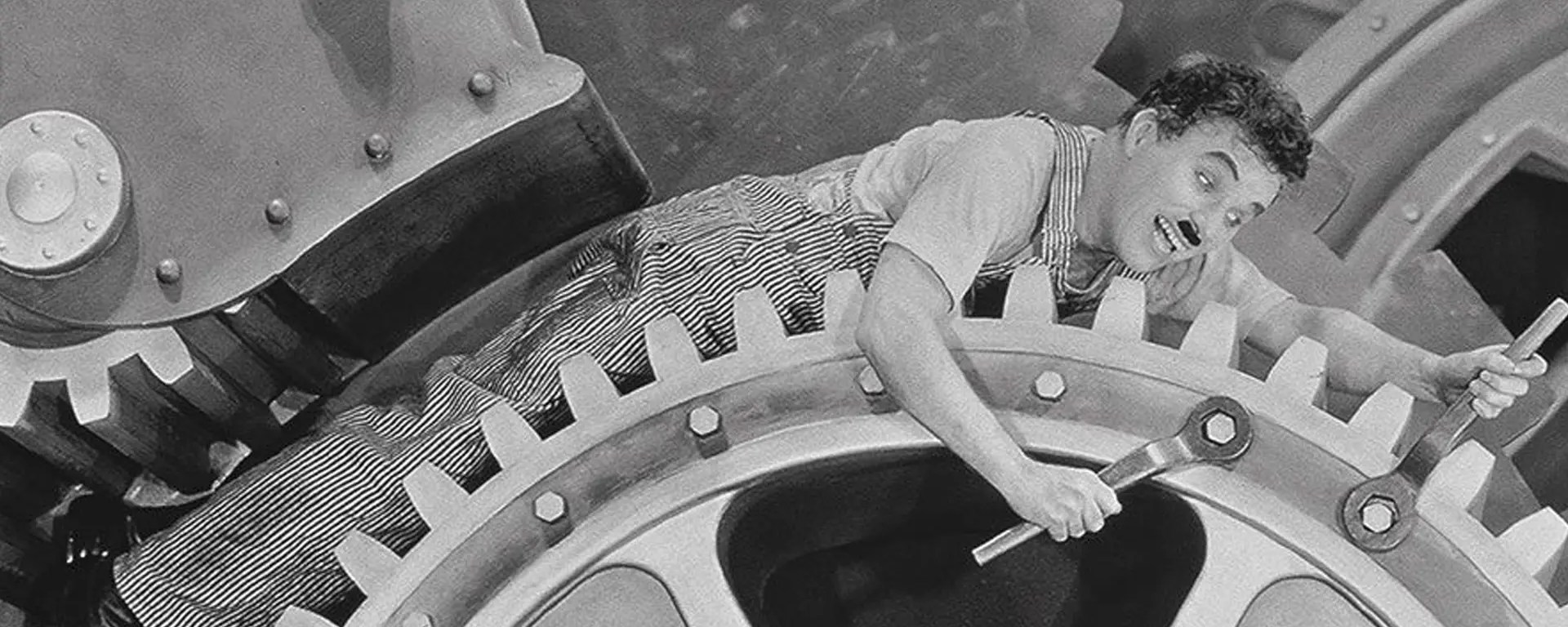 Charlie Chaplin trapped inside factory gears in Modern Times (1936)