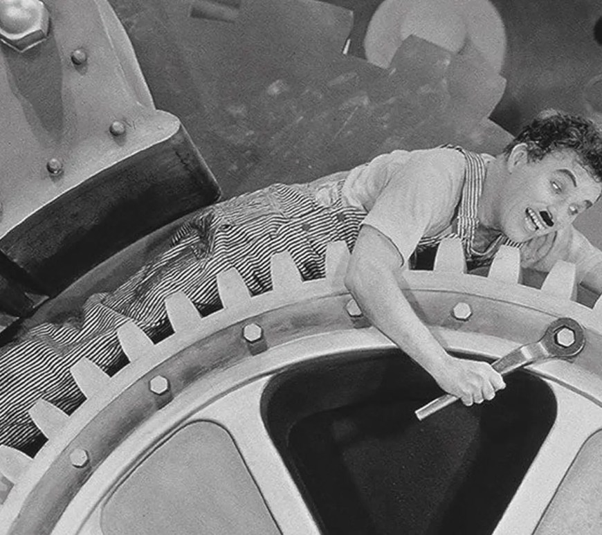 Charlie Chaplin trapped inside factory gears in Modern Times (1936)