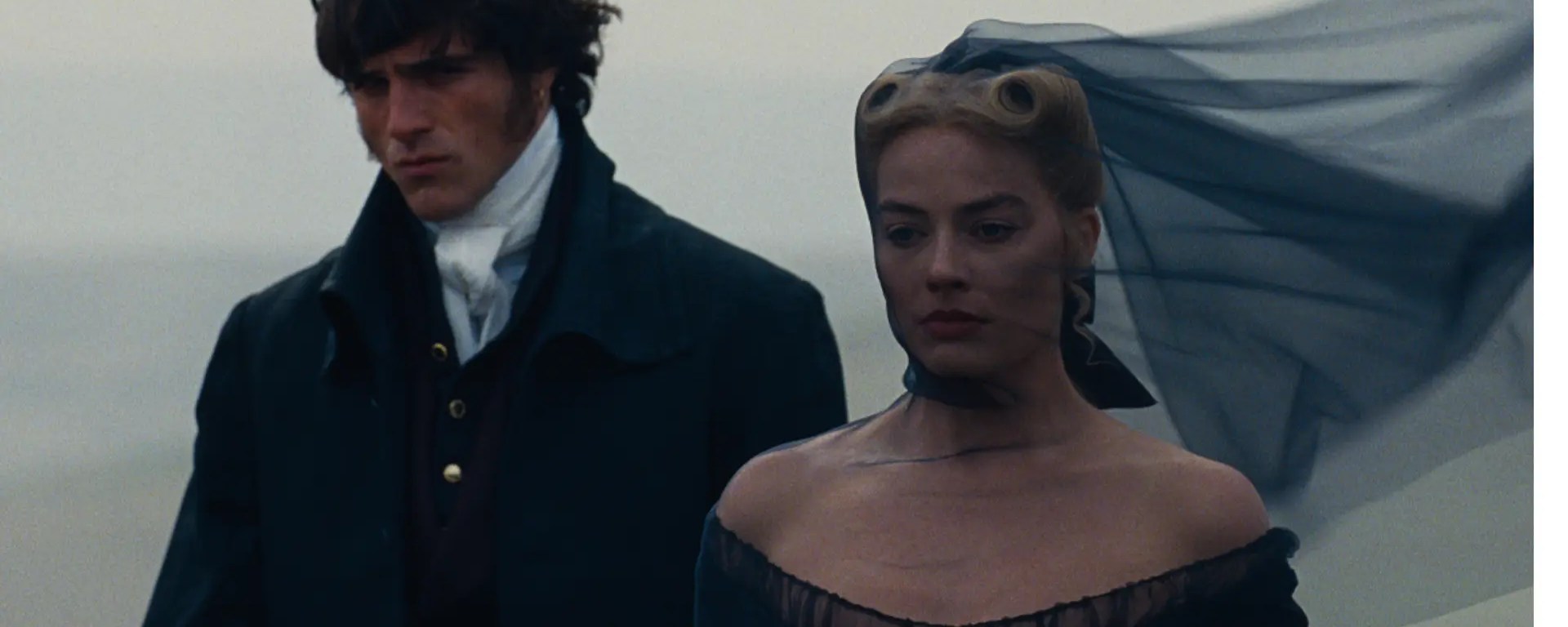Jacob Elordi and Margot Robbie in a stylized embrace from Emerald Fennell's Wuthering Heights, showcasing the film's "Quotation Mark" branding and high-fashion Gothic romance aesthetic.