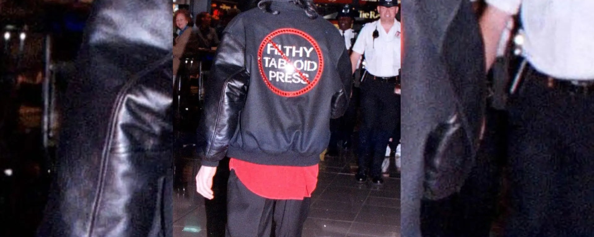 Michael Jackson wearing a jacket reading “Filthy Tabloid Press” during a public appearance