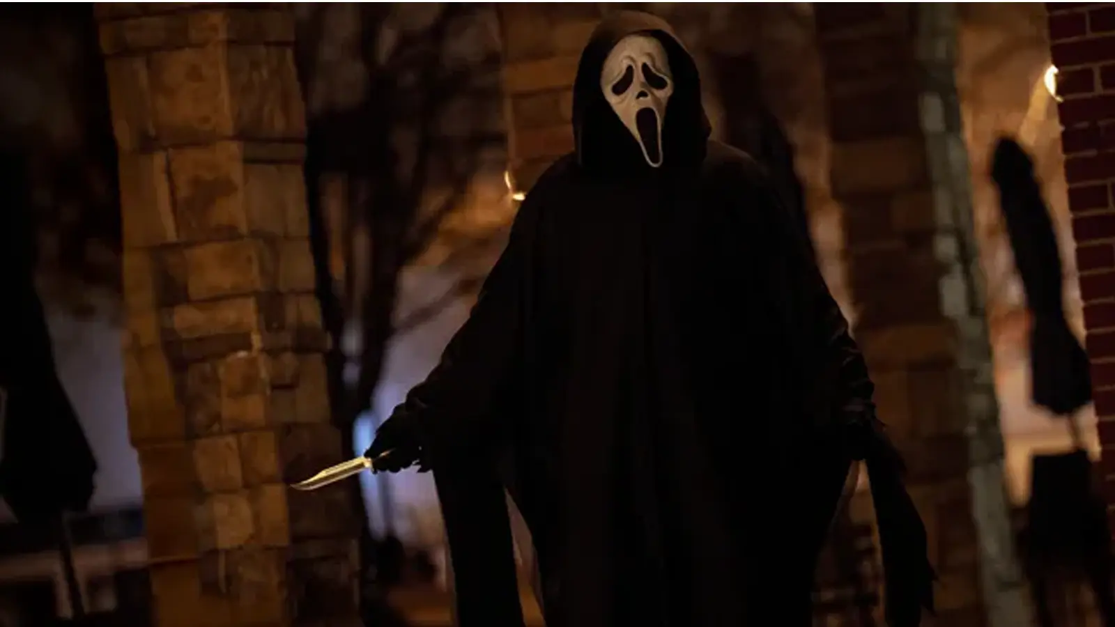 A high-fidelity cinematic still from Scream 7 featuring a dimly lit, anamorphic frame of the iconic Ghostface mask emerging from the shadows. The shot highlights the 2.39:1 aspect ratio and the return to the suburban-gothic visual architecture established by Kevin Williamson and Wes Craven in the original 1996 blueprint.