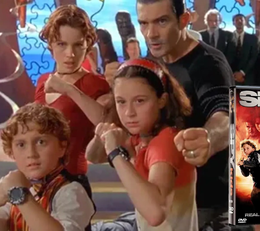A high-fidelity studio shot of the Spy Kids (2001) DVD case, featuring the Cortez family (Antonio Banderas, Carla Gugino, Alexa PenaVega, and Daryl Sabara). The archival physical media represents the 2001 transition from 35mm physical film to the early digital mastering era at Troublemaker Studios.
