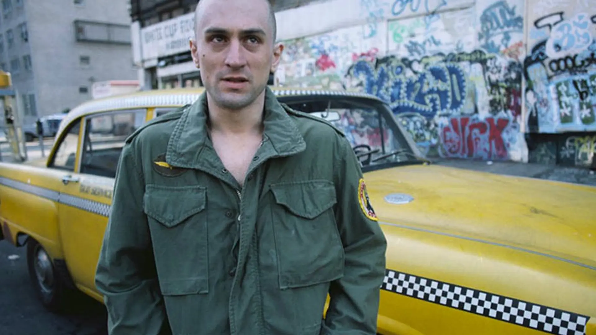 Close-up detail of the military-spec M-65 field jacket worn by Travis Bickle, featuring the iconic King Kong Company embroidered patch on the shoulder.