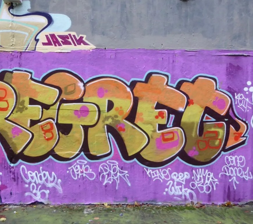 A vibrant, wide-angle shot of urban graffiti on a concrete wall, featuring overlapping layers of street art and political slogans that symbolize the loud, public fracturing of former political coalitions as discussed in the 'Manosphere' and influencer audit.