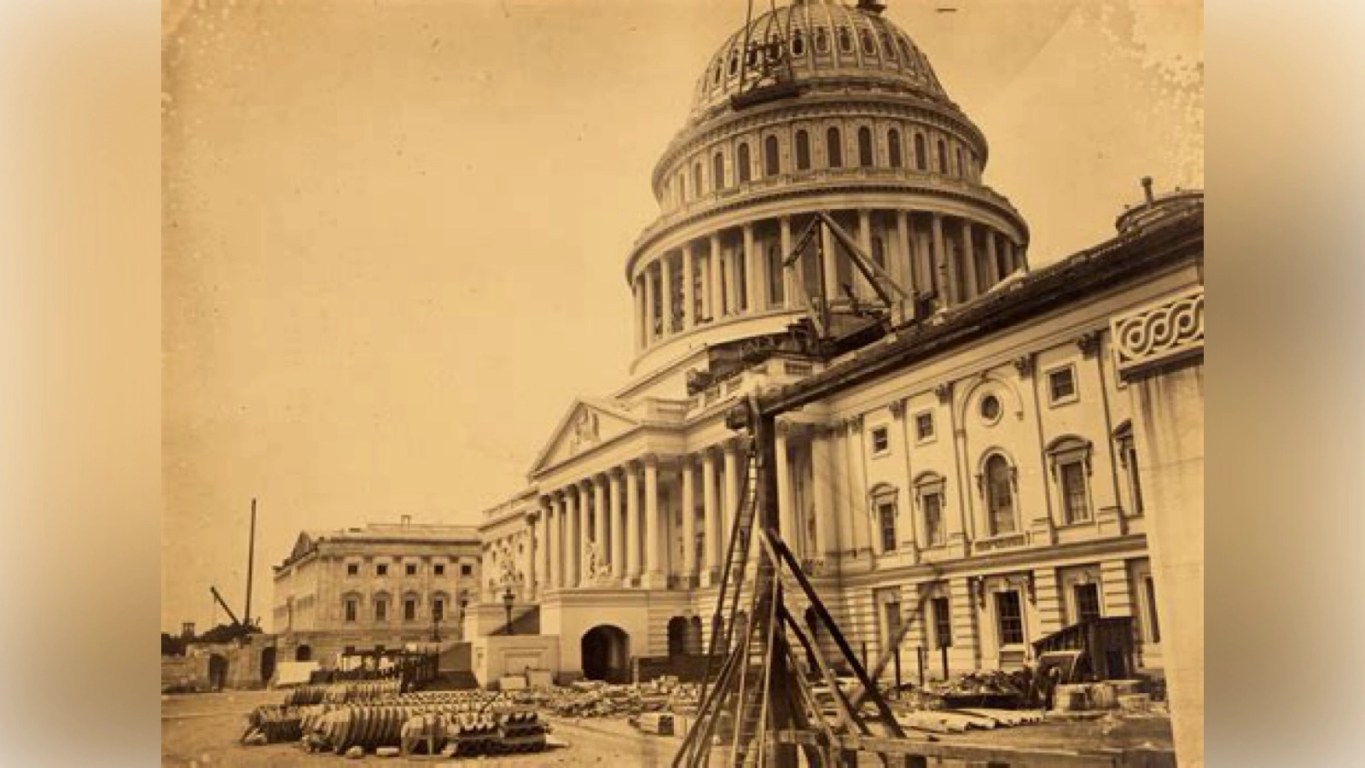 Historic 19th‑century engraving of the original U.S. Capitol building, showing the early architecture used by the Founders and the first Congresses, symbolizing the constitutional design at the heart of America’s war‑powers debate.