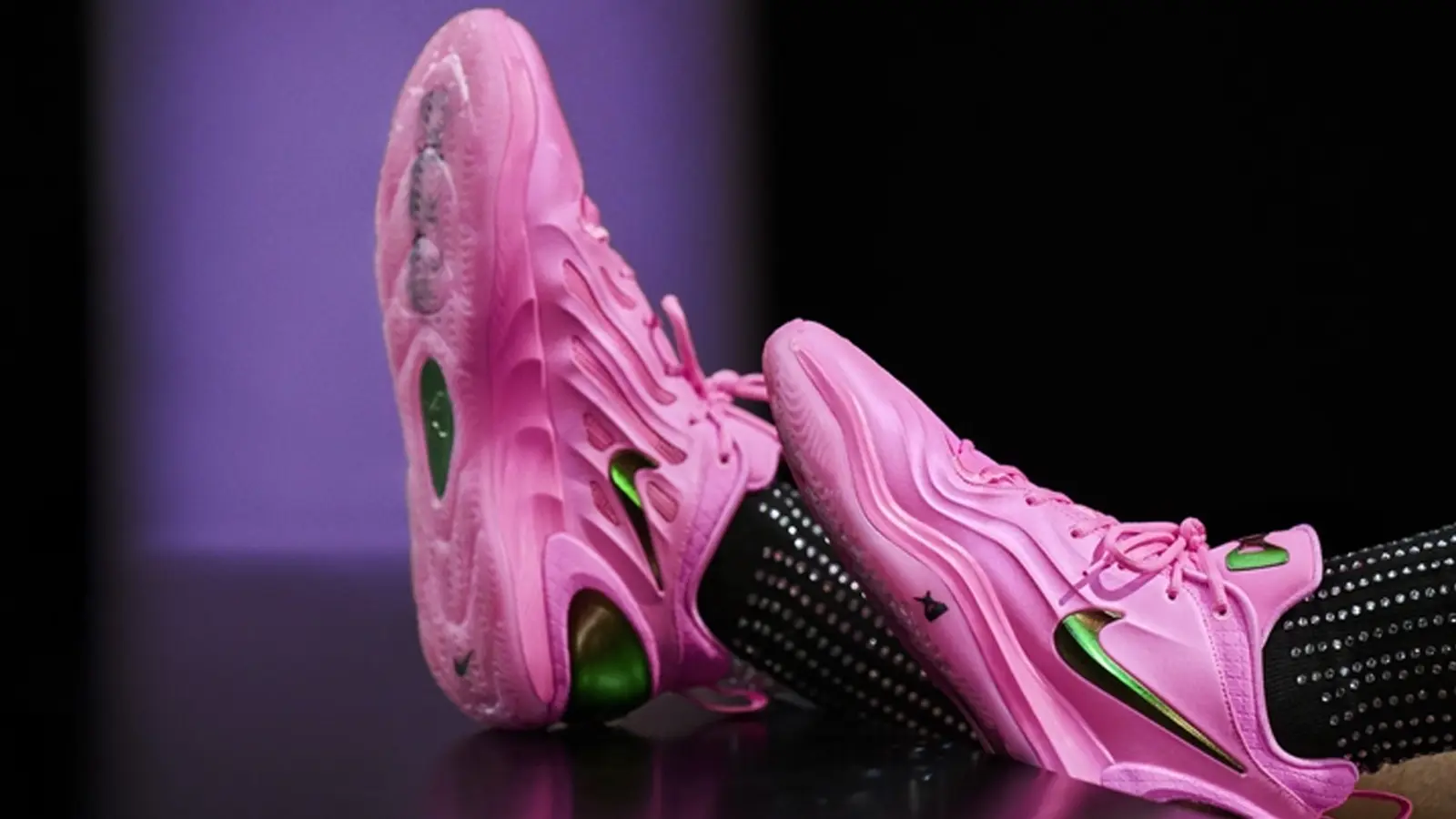 A’ja Wilson posing with the new Nike A’Two, showcasing the pearl-molded upper and the vibrant A’Pink colorway