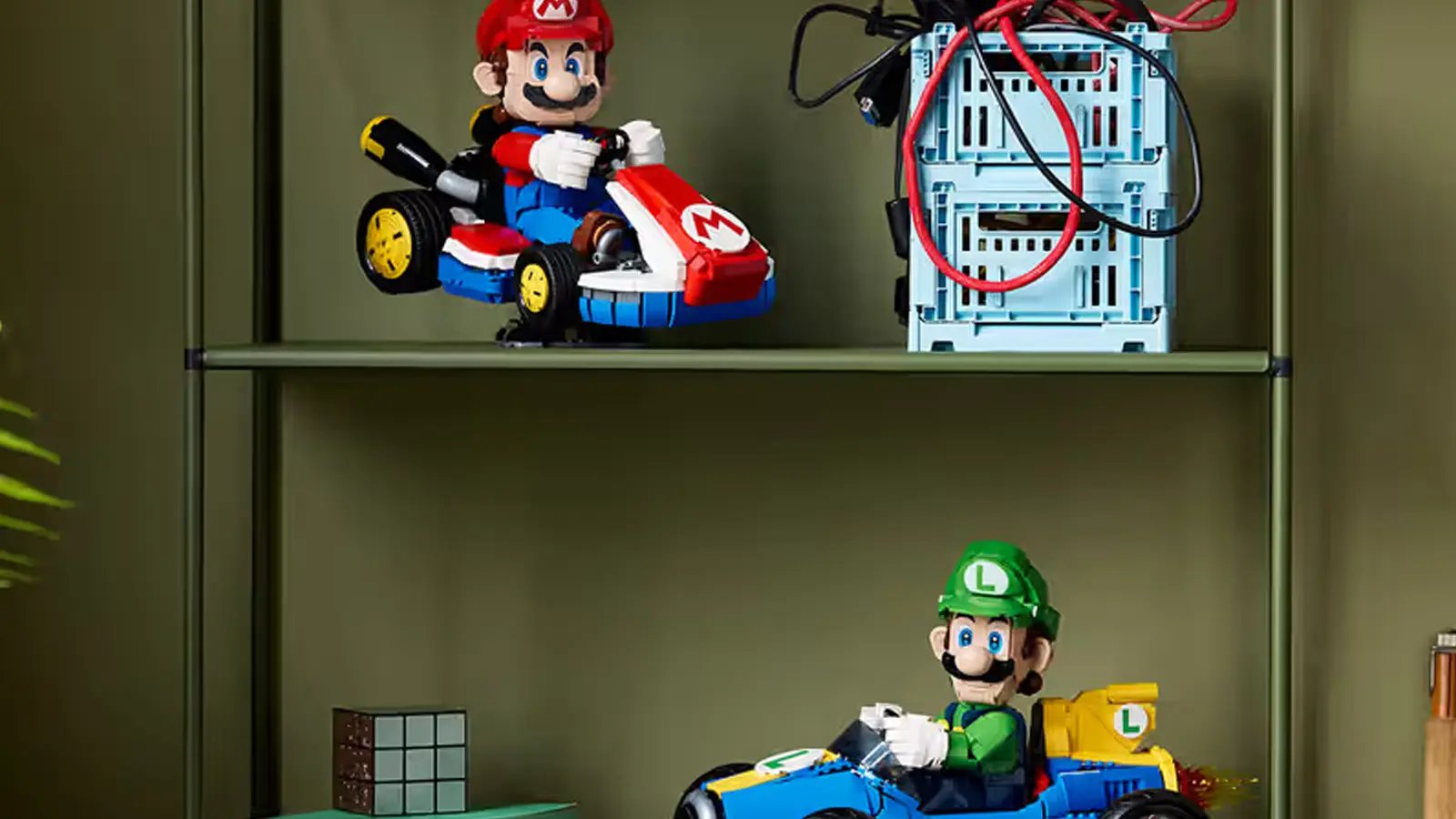 Detailed look at the LEGO 72050 Luigi and Mach 8 Mario Kart. The 2,234-piece 1:8 scale model is pictured at a 30-degree drift angle on its custom display stand, highlighting the functional steering and mechanical flame exhaust.