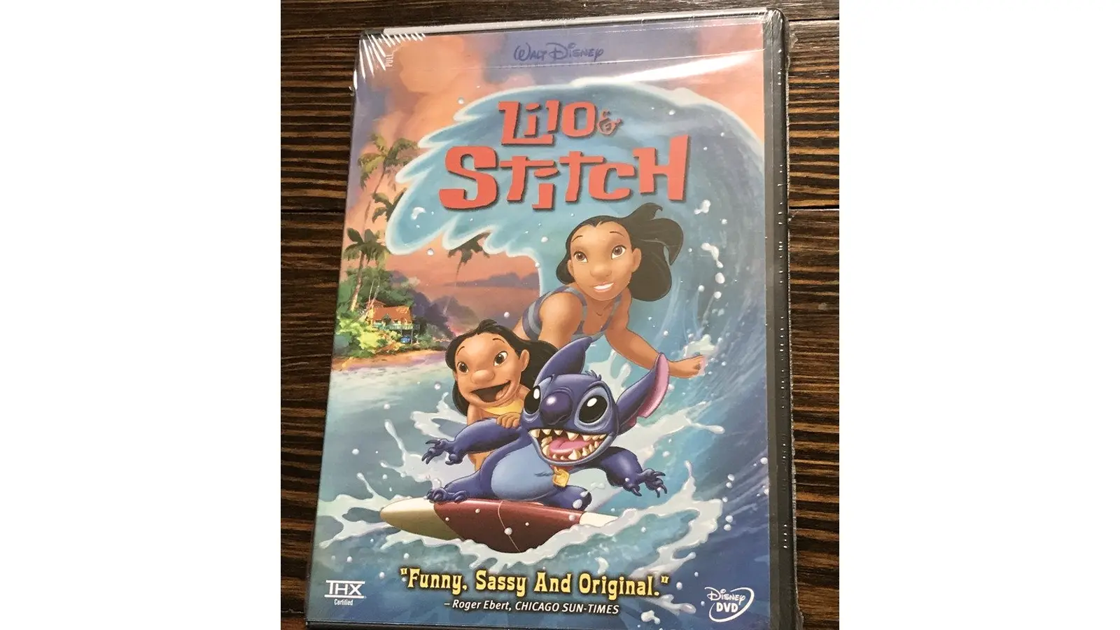 A high-quality still of Lilo and Stitch on the beach.