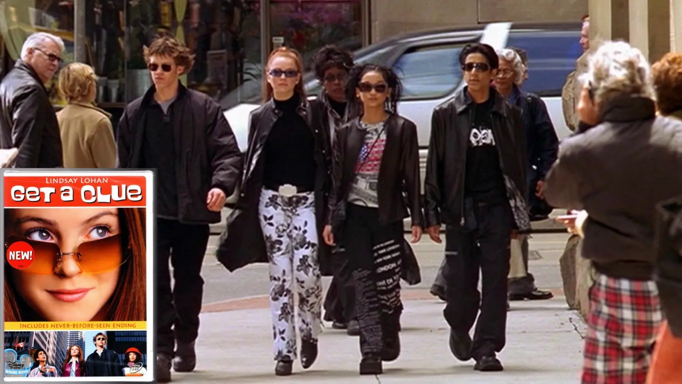 Film still from the final scene of Disney Channel’s Get a Clue (2002). The 'The Four'—Lexy Gold (Lindsay Lohan), Jack Downey (Bug Hall), Jennifer (Brenda Song), and Gabe (Ali Mukaddam)—are walking side-by-side down a New York City street. They are all wearing high-saturated Y2K fashion, including Lexy's pink newsboy cap and tweed mini-skirt, and Gabe's athletic blue pullover. They are laughing as they merge into the crowd of NYC pedestrians.