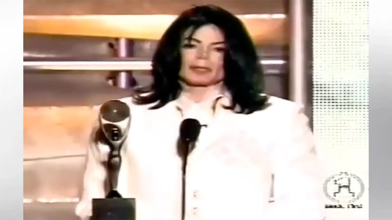 Michael Jackson in a white suit accepting his solo Rock and Roll Hall of Fame award in 2001