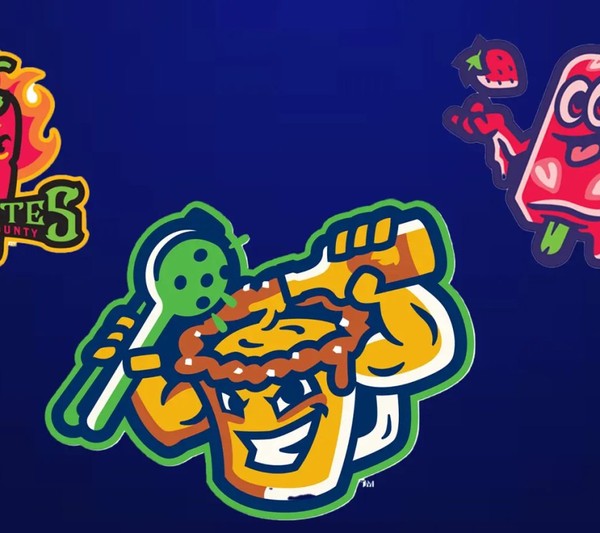 The Perros Calientes de Akron logo featuring a stylized hot dog with vibrant orange and blue flames, representing the RubberDucks' Copa de la Diversión identity.