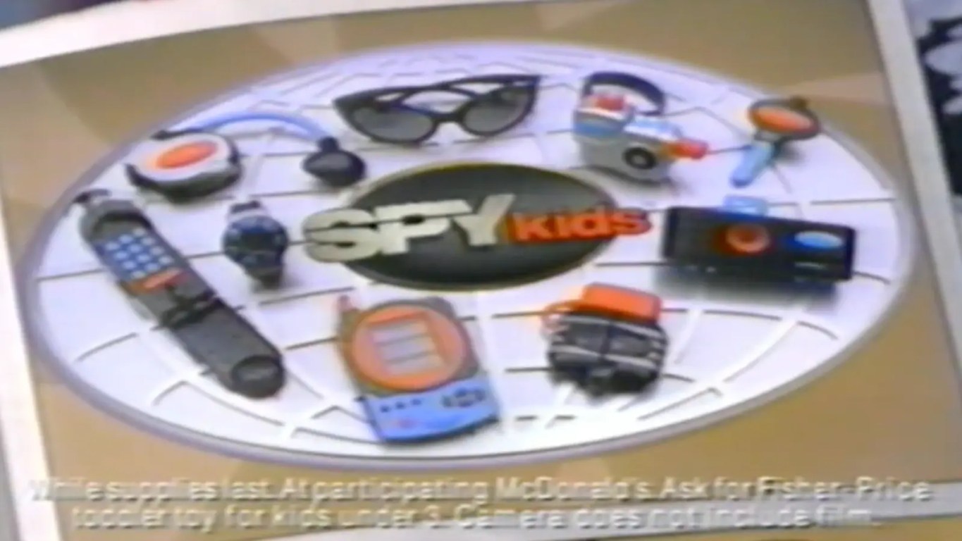 The complete 9-toy gadget kit from the 2001 McDonald’s Spy Kids Happy Meal, featuring the functional 110mm camera, motion detector, and spy watch.