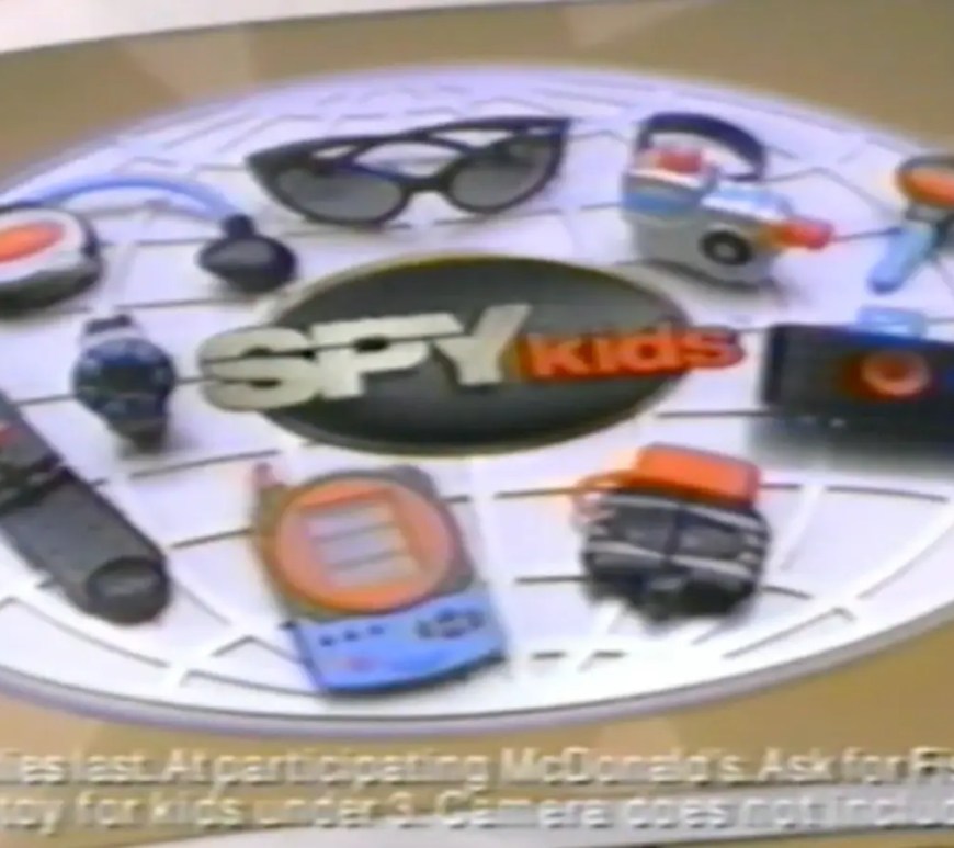 The complete 9-toy gadget kit from the 2001 McDonald’s Spy Kids Happy Meal, featuring the functional 110mm camera, motion detector, and spy watch.