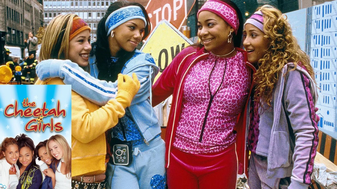 The Cheetah Girls (2003) movie poster featuring Raven-Symoné, Adrienne Bailon, Kiely Williams, and Sabrina Bryan in iconic colorful tracksuits and cheetah print headbands against a New York City backdrop.