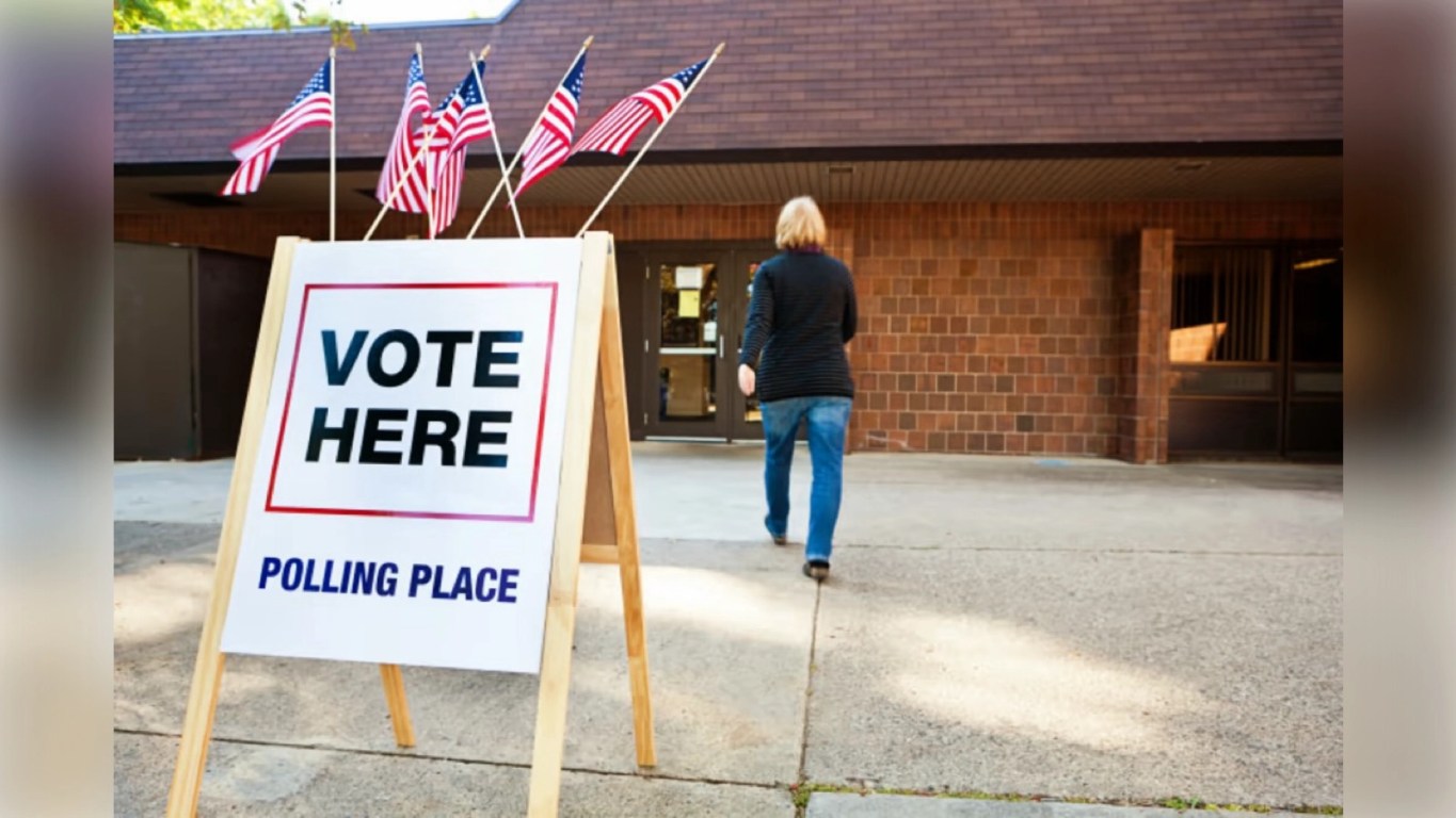 The Cracks Are Spreading: Democrats Send a Warning. Exterior of a polling place with a large ‘Vote Here’ sign displayed outside the building, photographed on Election Day.