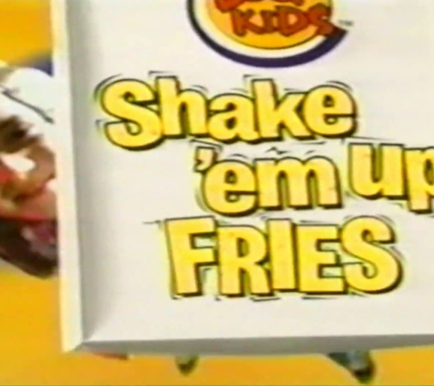 A 2002 Burger King Shake ‘Em Up Fries kit including the shaker bag and the orange cheese powder packet.