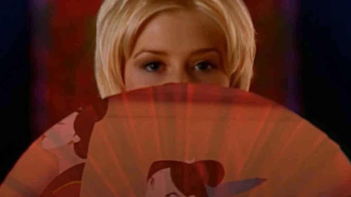 Christina Aguilera with a blonde bob singing in the 1998 Mulan music video at the Epcot Chinese Pavilion.