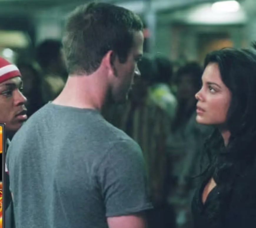 The original 2006 DVD cover for 'The Fast and the Furious: Tokyo Drift,' featuring a high-contrast, fiery orange and black aesthetic. The cover showcases the hero cars—Sean’s red Mitsubishi Lancer Evo IX and Han’s iconic orange VeilSide Mazda RX-7—stationary but blurred to suggest high-speed motion against a stylized Tokyo skyline, alongside a movie still.