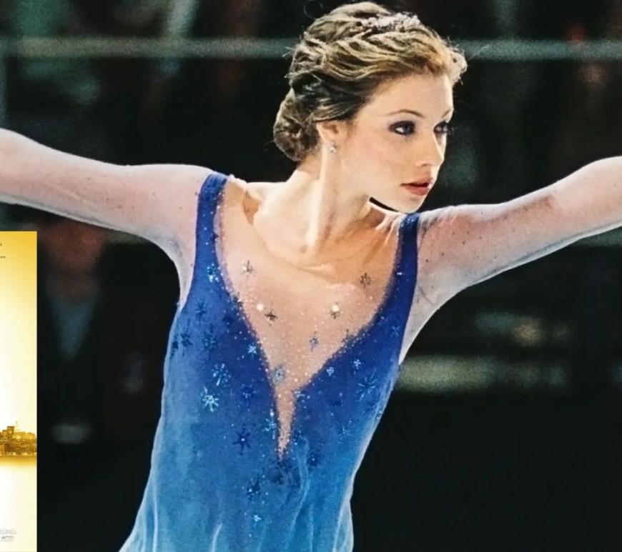 The original 2005 Disney DVD cover for Ice Princess, featuring Michelle Trachtenberg in a blue skating dress against a vibrant purple and pink background, with the tagline 'From Brainy to Beautiful' and Hayden Panettiere in the background.