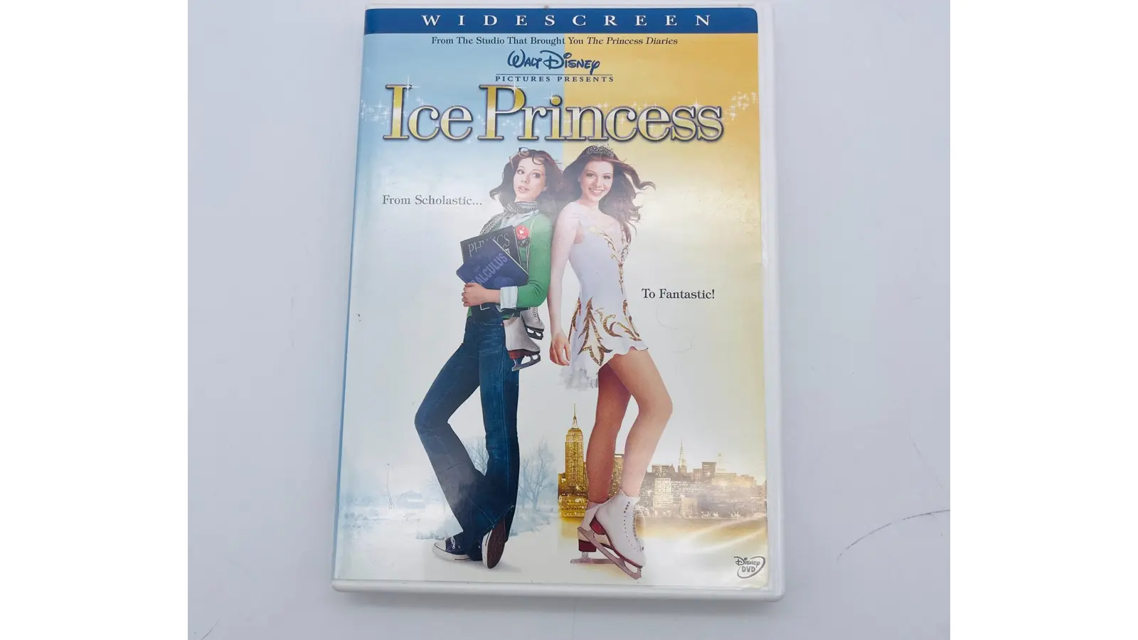 The original 2005 Disney DVD cover for Ice Princess, featuring Michelle Trachtenberg in a blue skating dress against a vibrant purple and pink background, with the tagline 'From Brainy to Beautiful' and Hayden Panettiere in the background.