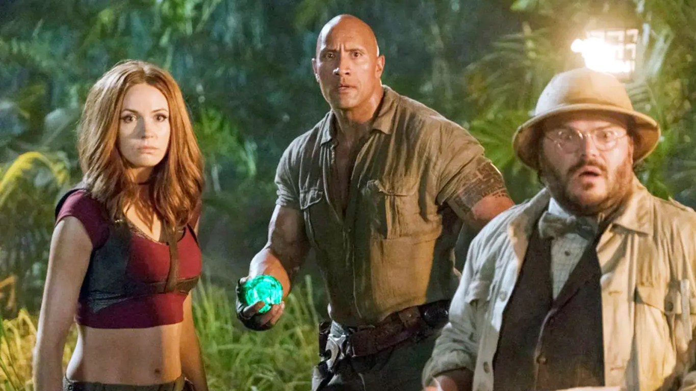 Dwayne Johnson, Kevin Hart, Jack Black and Karen Gillan walking through a jungle in Jumanji: Welcome to the Jungle.