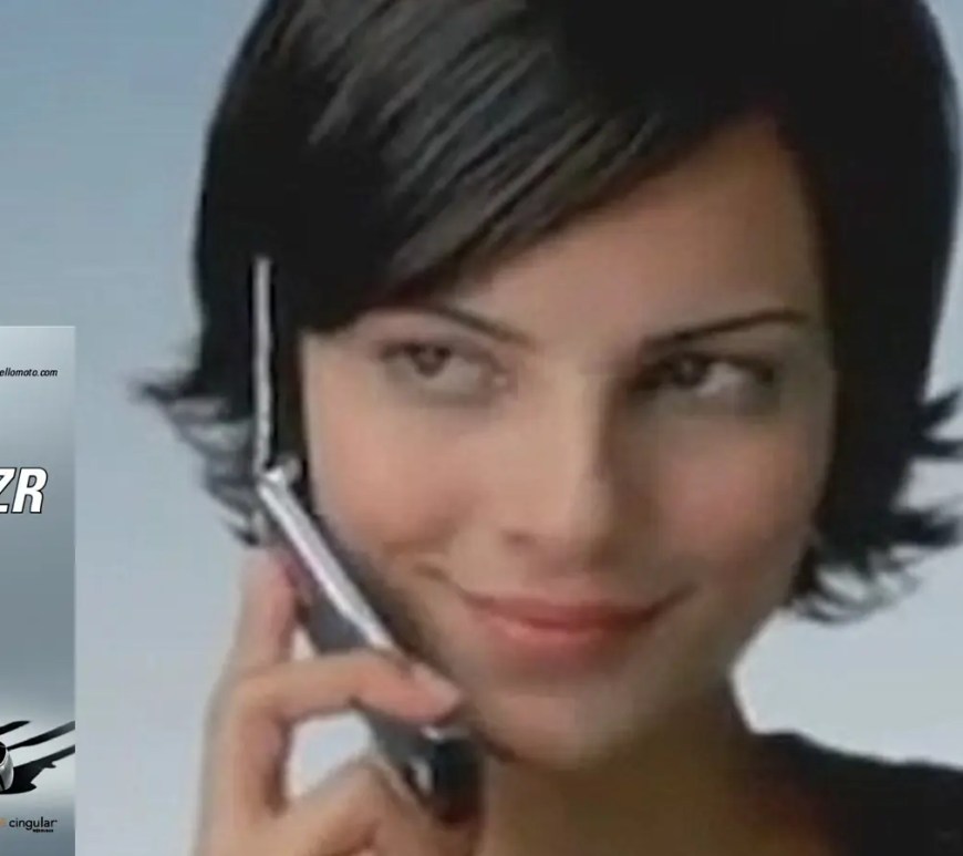 The original 2004 Motorola Razr V3 in Silver Quartz, showcasing its ultra-slim aluminum profile and etched metal keypad with blue backlighting.