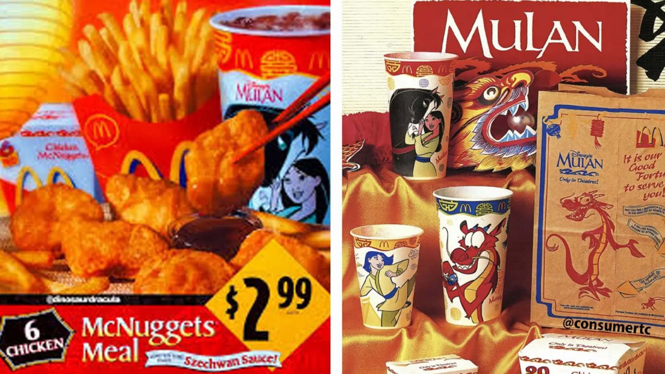 A vintage 1998 McDonald’s Happy Meal display for Disney’s Mulan. The centerpiece is a red Happy Meal box featuring high-action illustrations of Mulan and Mushu. Surrounding the box are several of the eight 'Standard Issue' wind-up toys, including Mulan in her imperial armor, a galloping Khan the horse, and Mushu with his gong. In the foreground is an original, unopened packet of the legendary Szechuan Dipping Sauce, featuring its distinctive purple-and-white foil lid and 1998 Disney copyright branding.