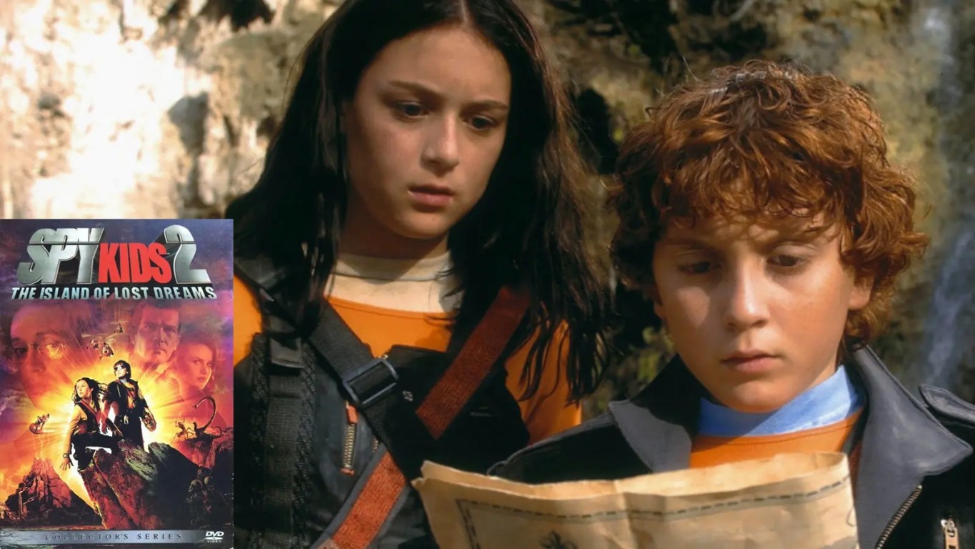 The official DVD cover for Spy Kids 2: Island of Lost Dreams, featuring Carmen and Juni Cortez in tactical gear, surrounded by high-tech gadgets, mutated hybrid creatures, and the rival Giggles siblings against a tropical island backdrop.