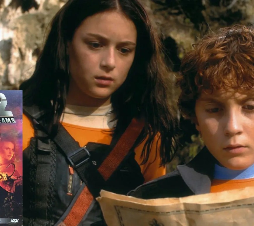 The official DVD cover for Spy Kids 2: Island of Lost Dreams, featuring Carmen and Juni Cortez in tactical gear, surrounded by high-tech gadgets, mutated hybrid creatures, and the rival Giggles siblings against a tropical island backdrop.
