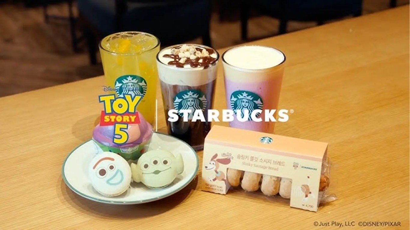Starbucks Toy Story 5 mugs featuring Woody and Jessie with removable cowboy hat lids and a Slinky Dog handle cup.