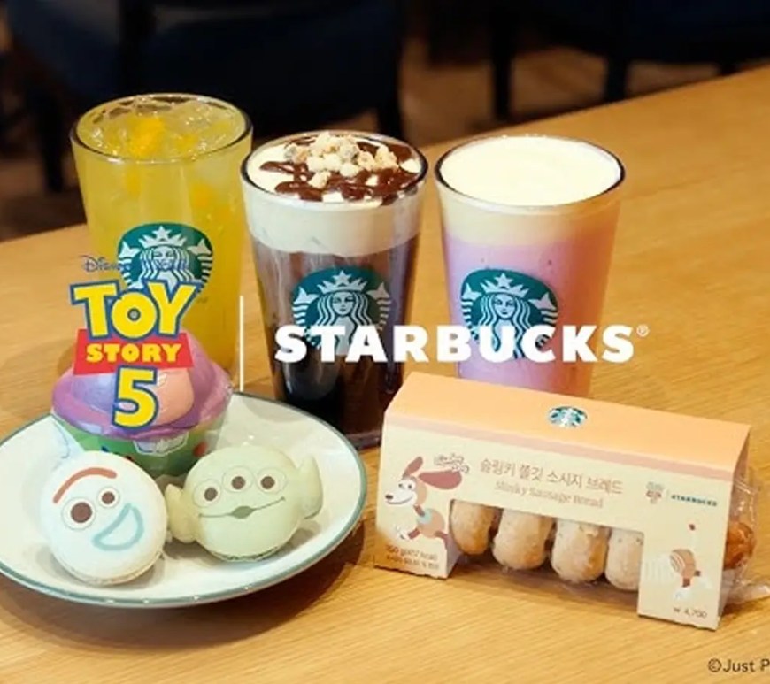Starbucks Toy Story 5 mugs featuring Woody and Jessie with removable cowboy hat lids and a Slinky Dog handle cup.