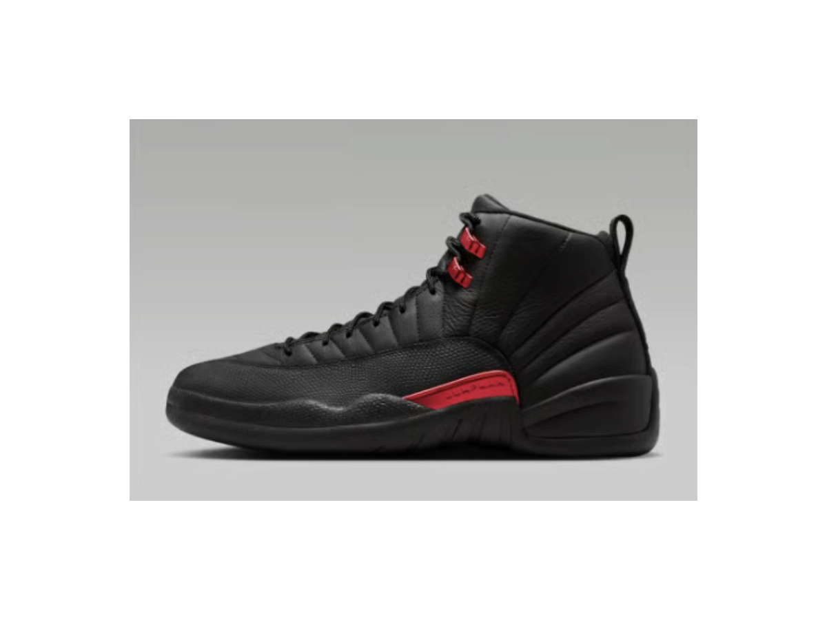 Side profile view of the Air Jordan 12 Bloodline sneaker, highlighting the iconic stitched paneling and the varsity red midfoot branding tab.