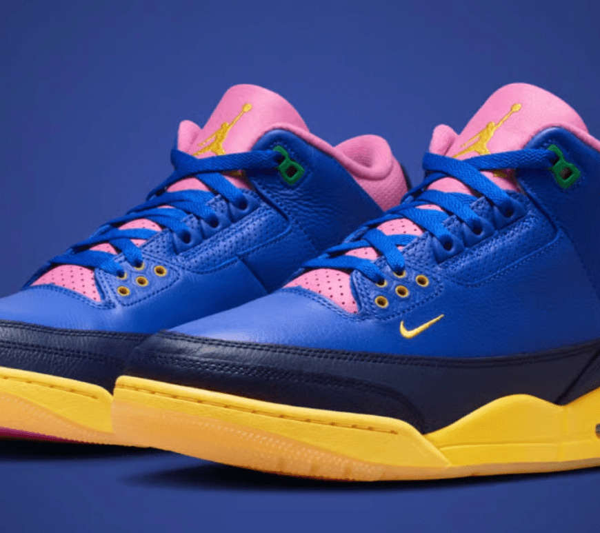 Alt Text: A side-profile shot of the Air Jordan 3 Retro "Brazil" sneaker, highlighting its deep blue leather upper and textured blue panels. The classic silhouette features a sharp yellow midsole accent near the heel, a green rubber outsole, and a distinct pop of bright pink on the padded ankle collar.