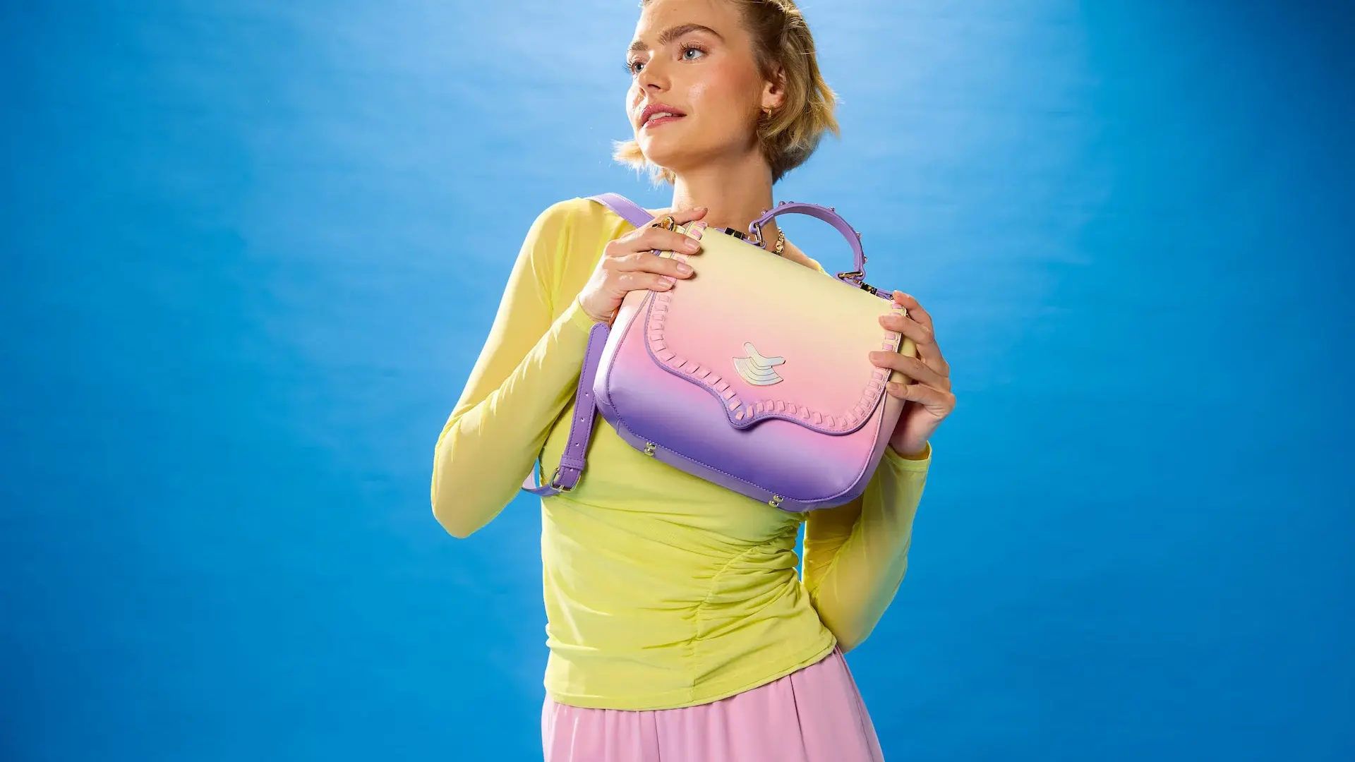 A a matching Lakeside-inspired bag with lace detailing and a pearlescent emblem, designed to transition from Galaxy’s Edge to everyday street style.