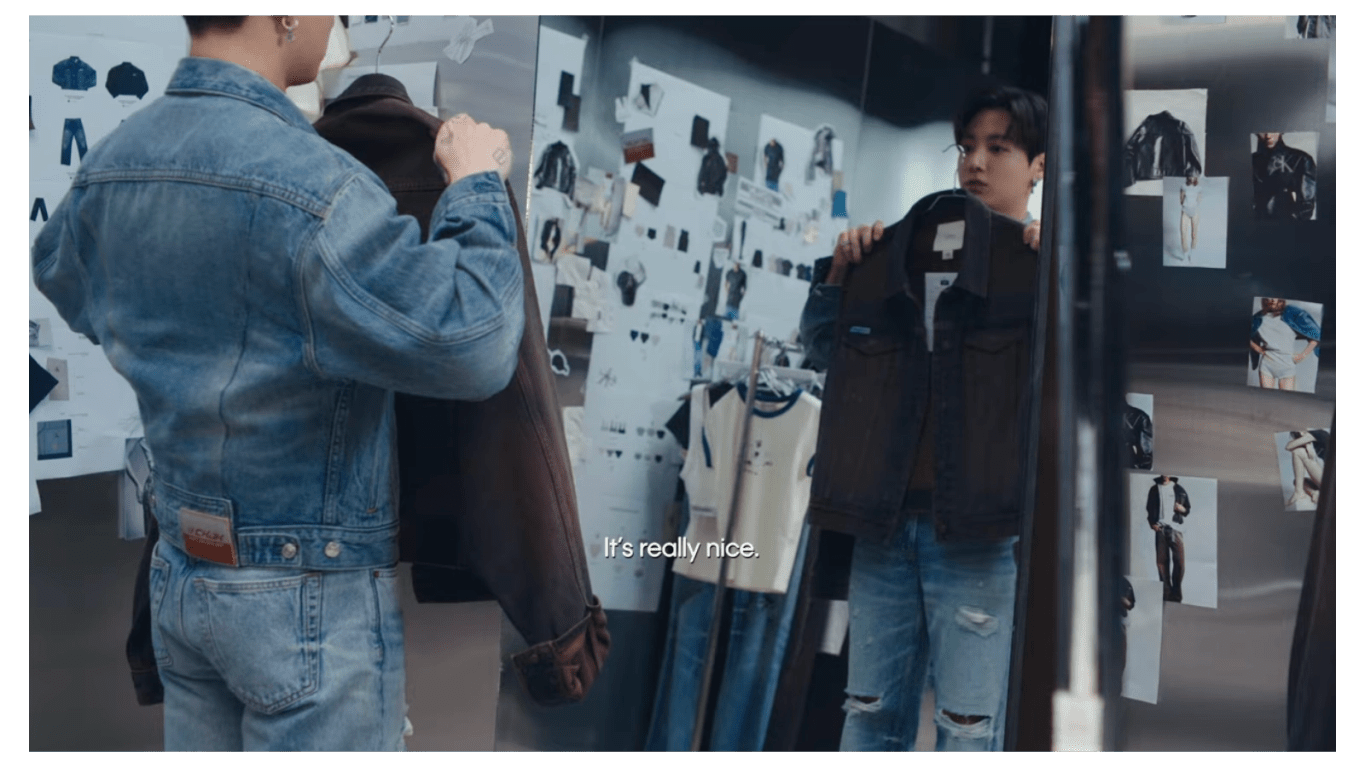 A still of Jung Kook describing his Calvin Klein collection while showcasing the denim jeans and jacket