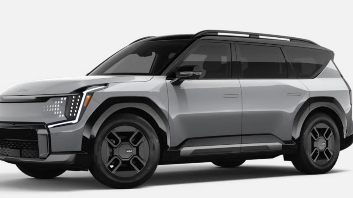 A side profile shot of the Kia EV9 displaying the silver trim color way and black tires.