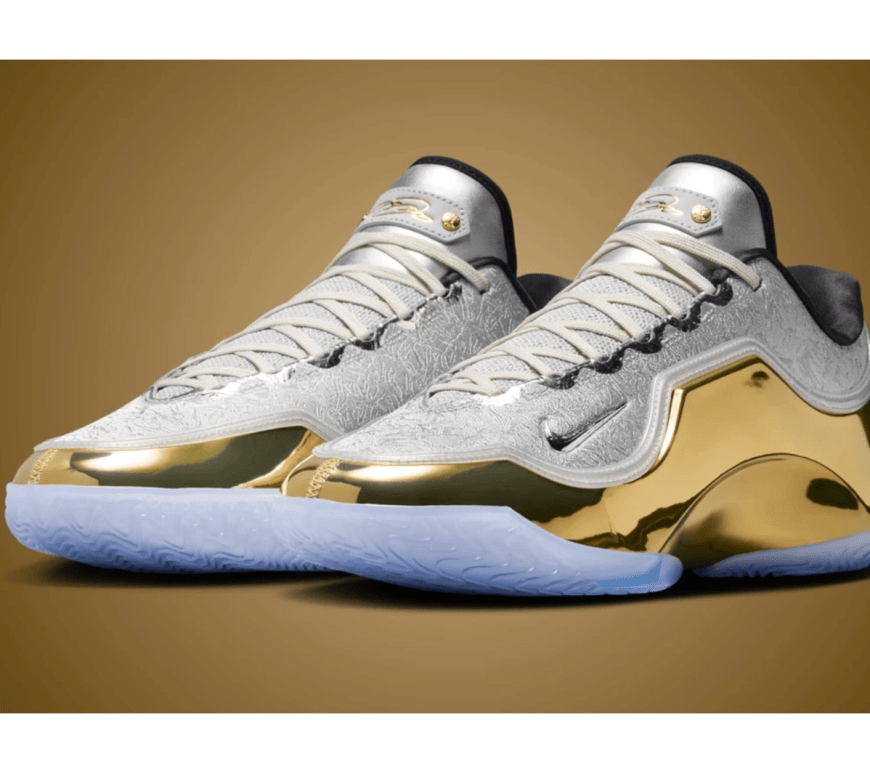 Side profile of the 2026 Nike LeBron 23 Lux Dreams and Nightmares sneaker, showing the metallic silver jacquard upper and gold-plated crown containment armor.