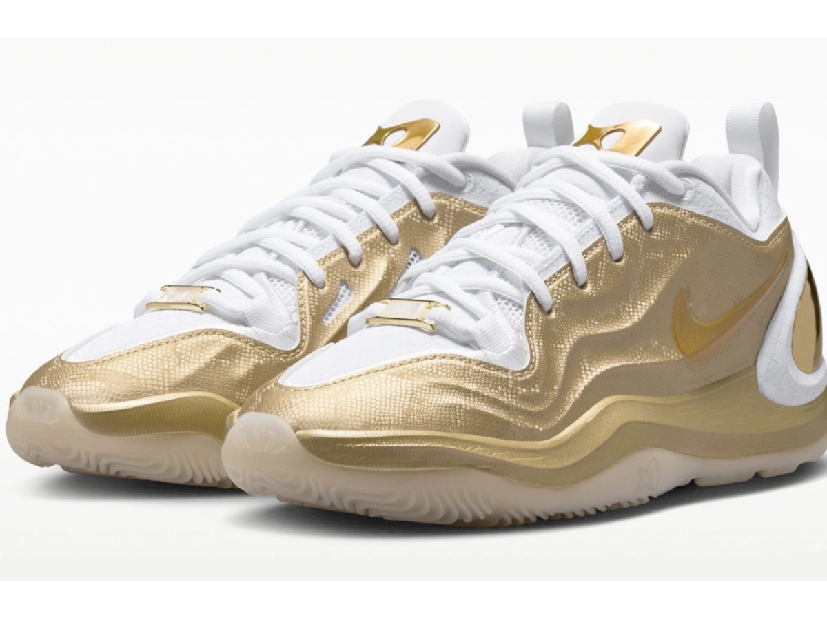 A look at the Nike A'Two Signature Shoe with gold detailing and white laces.