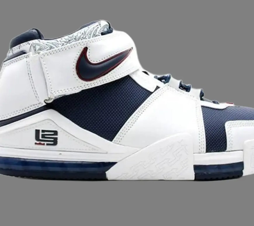 A high-contrast studio profile product shot of the vintage 2004 Nike Zoom LeBron II sneaker, highlighting the leather overlays and removable ankle strap hardware against a grey background.