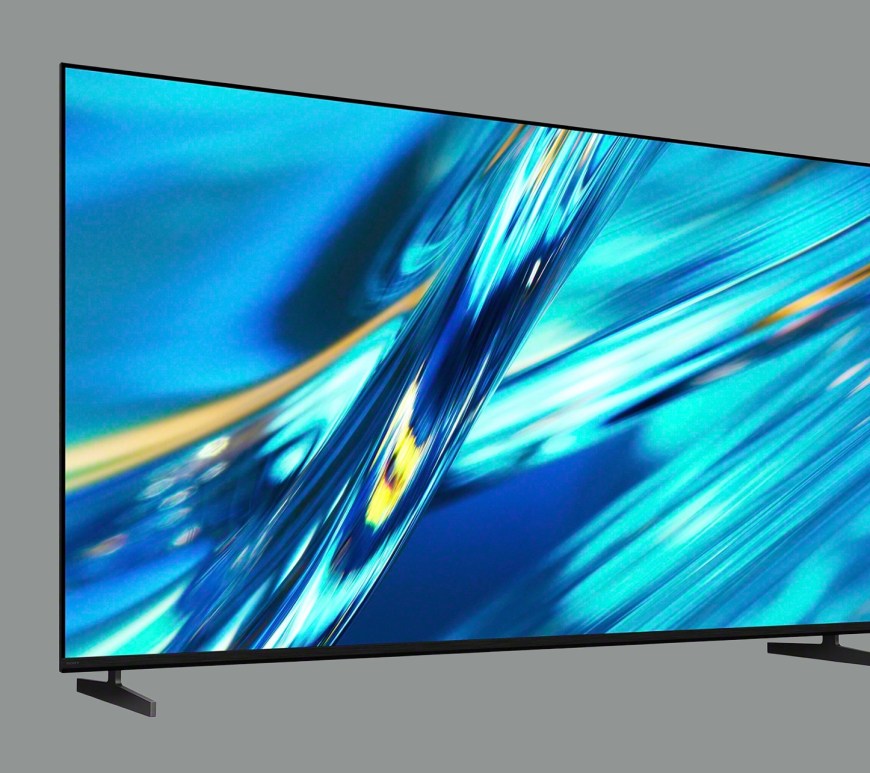 A front-view product shot of the 100-inch Sony BRAVIA 3II series 4K HDR LED TV. The television features a minimalist, "Seamless Edge" bezel design in a matte black finish, maximizing the screen-to-body ratio for an immersive viewing experience. It is supported by slim, dark silver wedge-style "Slim Blade" dual-position stands. The screen displays a high-fidelity, vibrant nature scene using Sony’s XR Triluminos Pro technology, illustrating the deep contrast and AI-driven color accuracy of the Cognitive Processor XR.