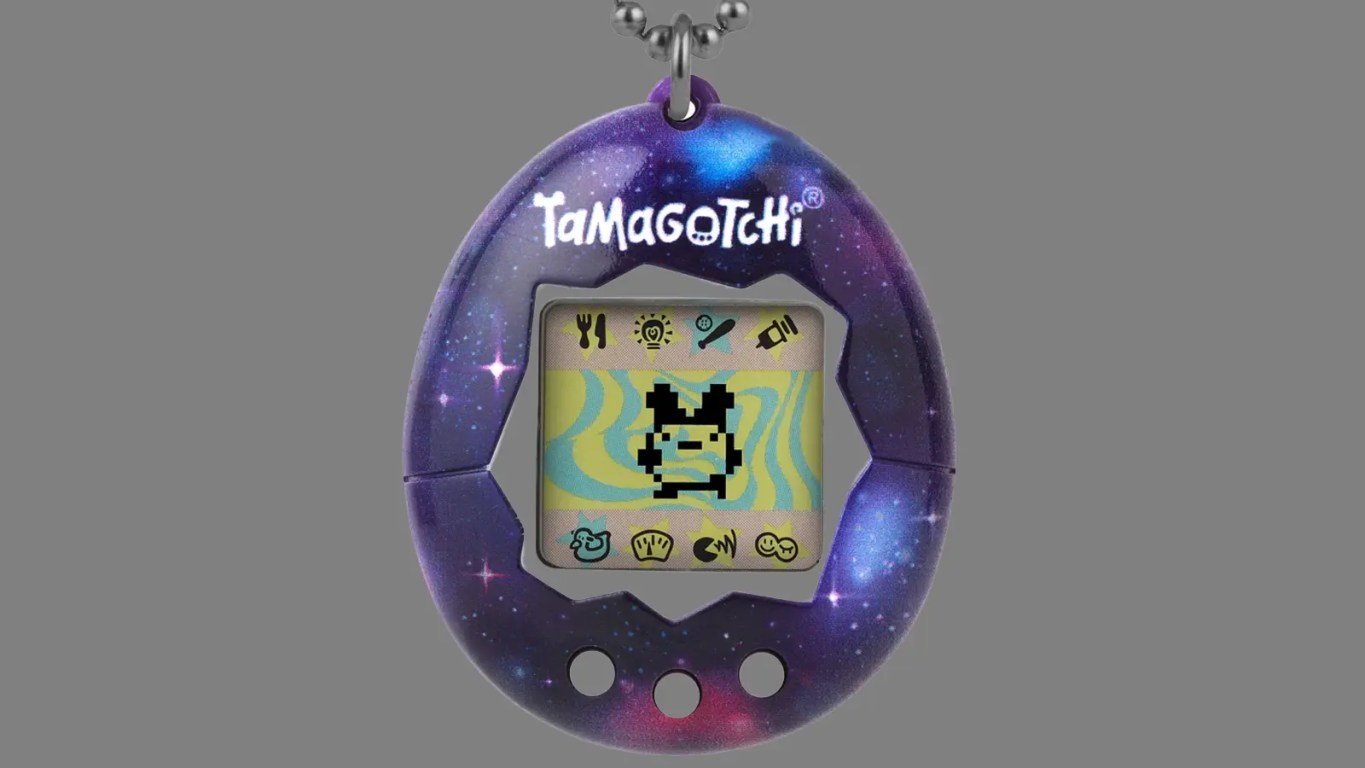 An archival close-up studio shot of a vintage 1997 Gen 1 Bandai Tamagotchi in its iconic translucent blue plastic egg casing, showcasing the 3-button layout and pixelated character on the LCD display.