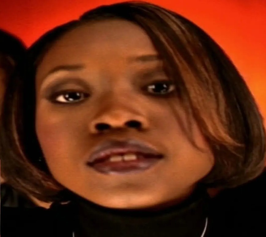 A vintage promotional photograph from the 1996 music video for 702's 'Steelo', showcasing Kameelah Williams, Irish Grinstead, and LeMisha Grinstead in classic mid-90s streetwear.