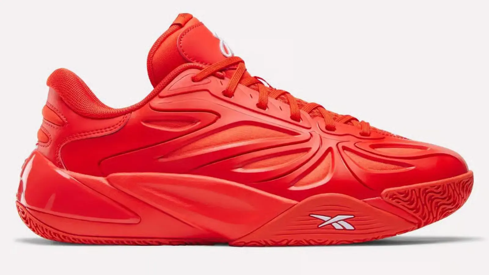 Red Reebok Angel Reese 1 signature basketball shoe featuring contrasting white branding and performance-focused design details.