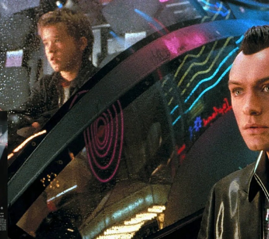 A haunting, neon-lit cinematic film still from the 2001 movie A.I. Artificial Intelligence, showing Haley Joel Osment as David looking up with wide, lifelike eyes.