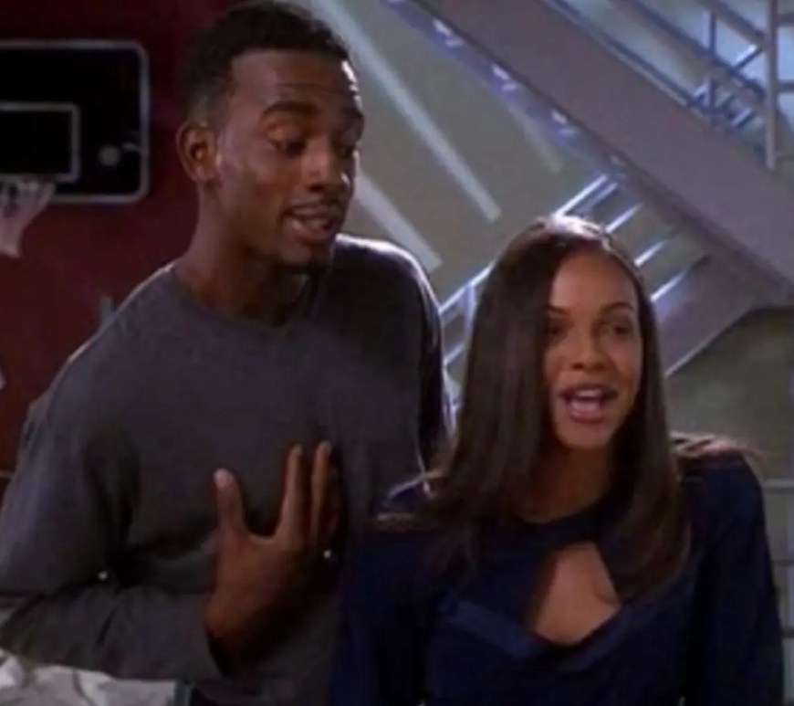 A vibrant still Bill Bellamy dressed in slick late-90s fashion, smiling confidently alongside cast members in 'How to be A Player' (1997)