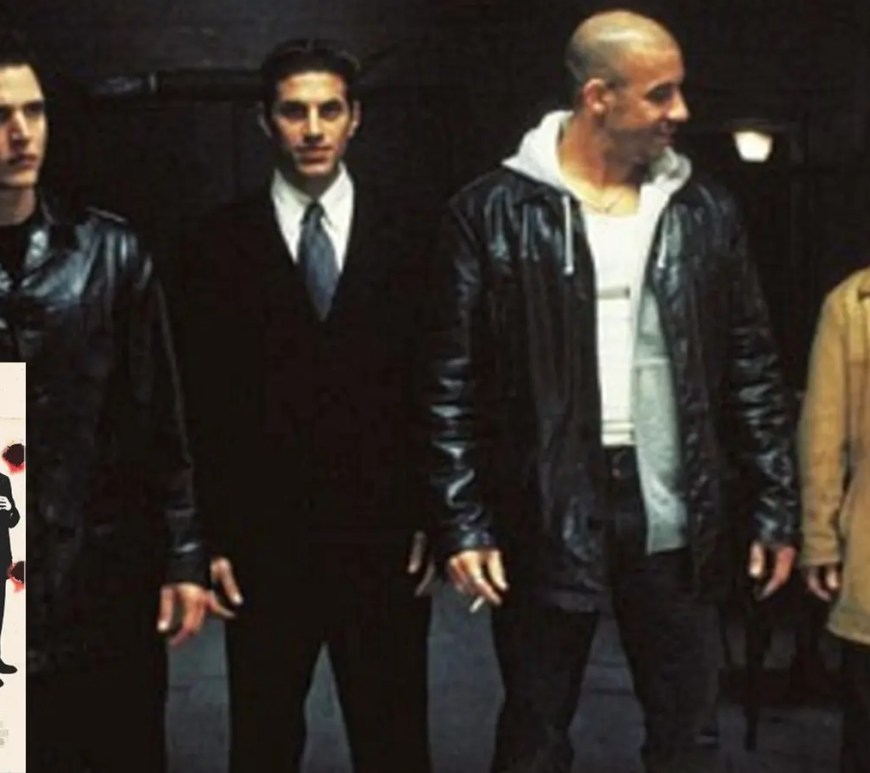 A desaturated, gritty cinematic promotional still from the 2001 movie Knockaround Guys, capturing Vin Diesel as Taylor Reese on location in a stark midwestern town landscape.